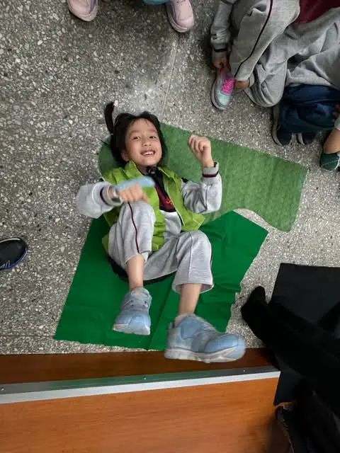 A child playing a small animal during the class